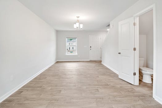 Bright and open living room with wooden floors, ideal for modern living.