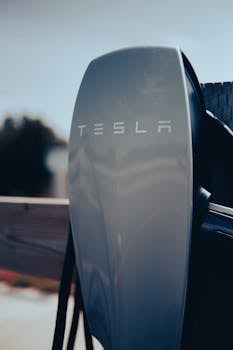 Close-up of a Tesla charging station, showcasing modern electric vehicle technology.